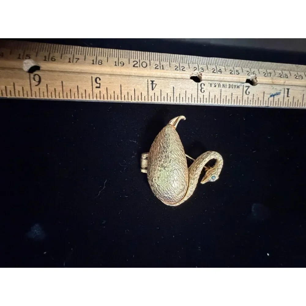 vtg.  Gold toned Swan Brooch/locket with Green Rhinestone eyes and opens up to